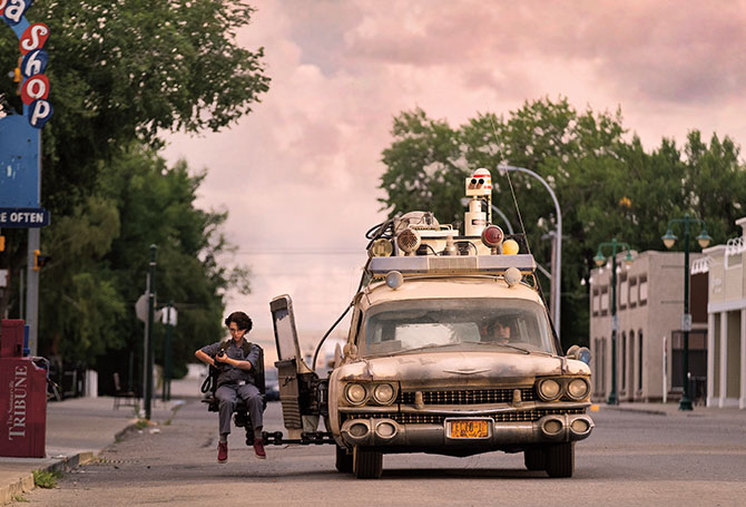 Kid sitting on the extension of a car