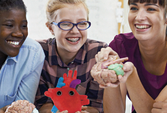 Image of students playing with squishy microbes